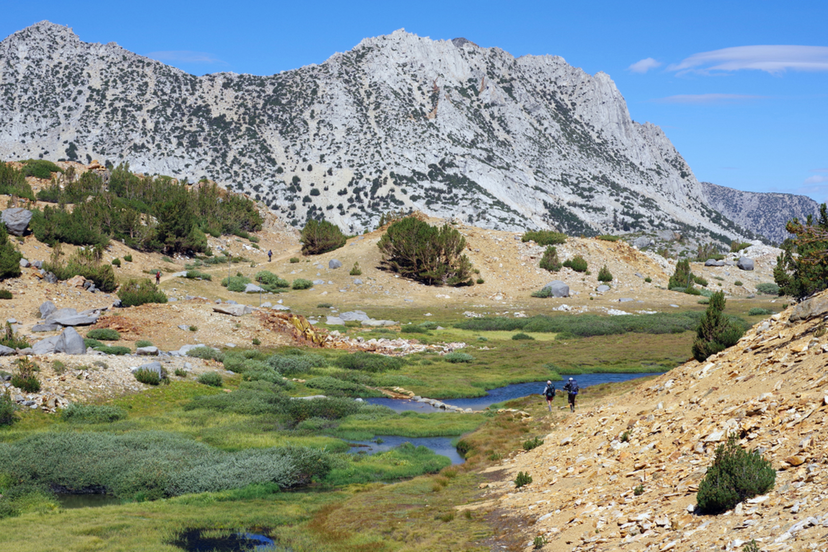 An image depicting the trail Treasure Lakes via Bishop Pass Trail and its surrounding area.