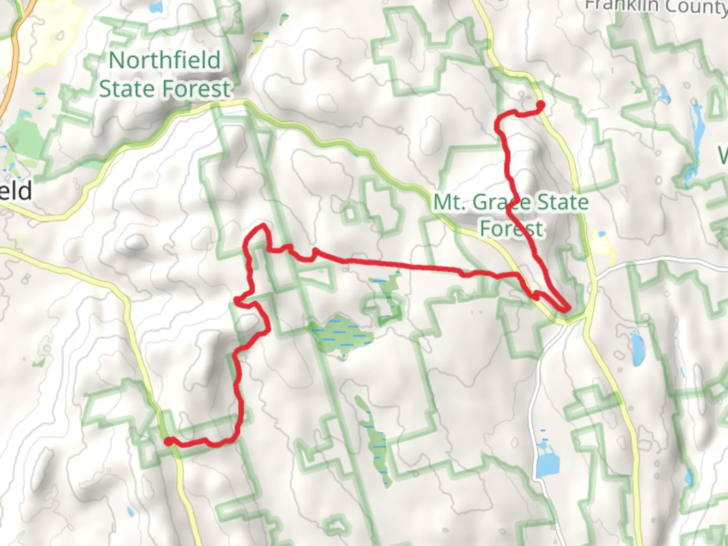 An image depicting the trail Gulf Road to Mount Grace State Forest and its surrounding area.