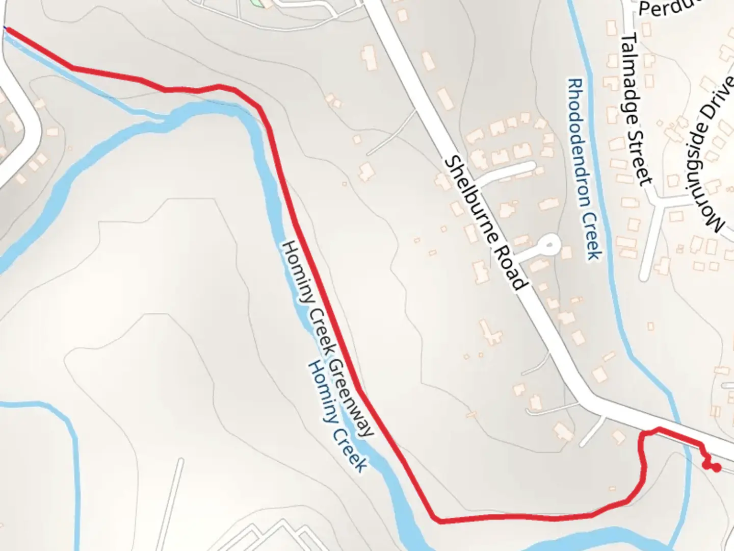 An image depicting the trail Hominy Creek Greenway and its surrounding area.