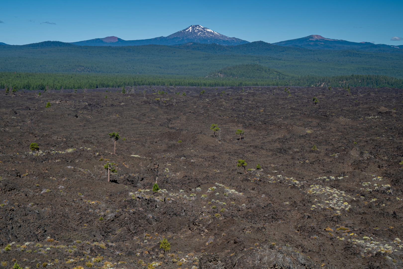An image depicting the trail Phil Brogan View Point via Trail of the Molten Land and its surrounding area.