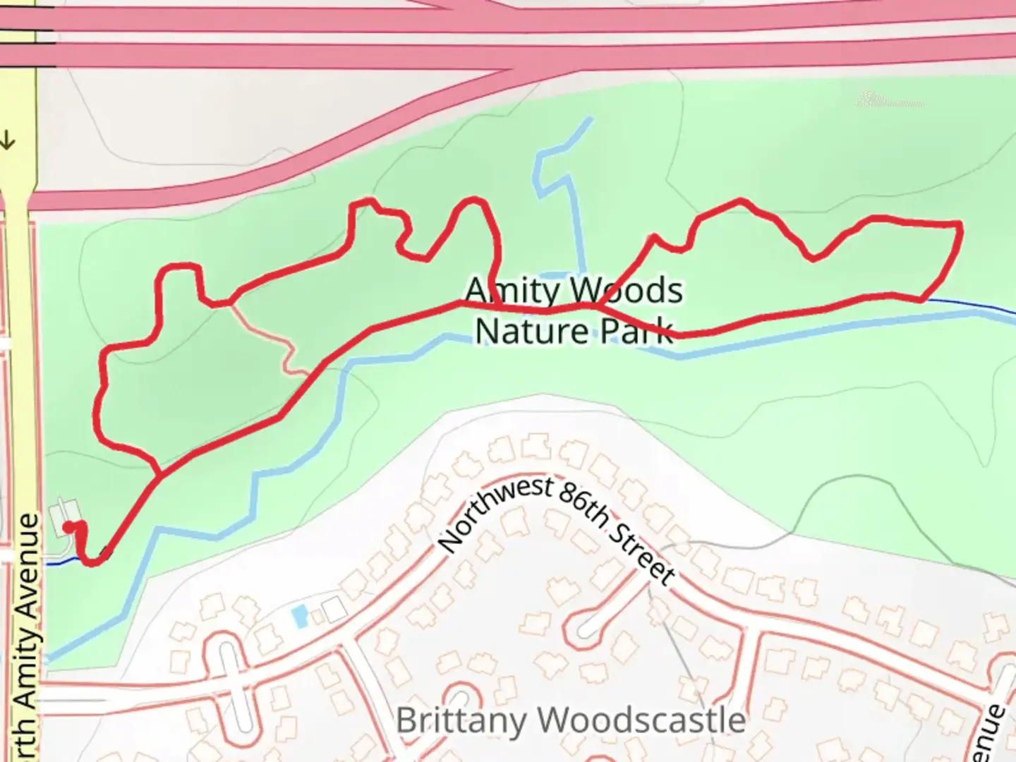 An image depicting the trail Amity Woods Nature Park Loop and its surrounding area.