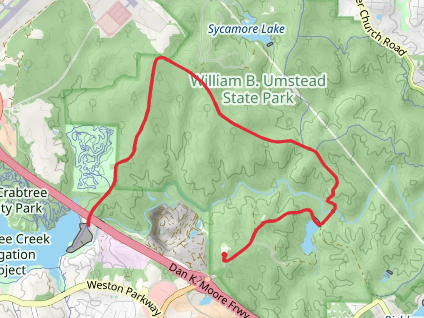 An image depicting the trail Reedy Creek Multi-Use Trail to Lake Crabtree and its surrounding area.