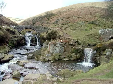 An image depicting the trail Three Shire Heads Loop and its surrounding area.