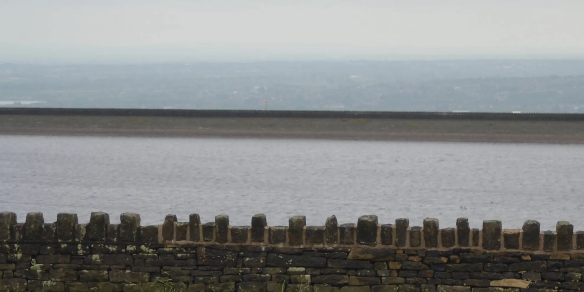 An image depicting the trail Turf Moor and Black Hill from Ashworth Reservoir and its surrounding area.