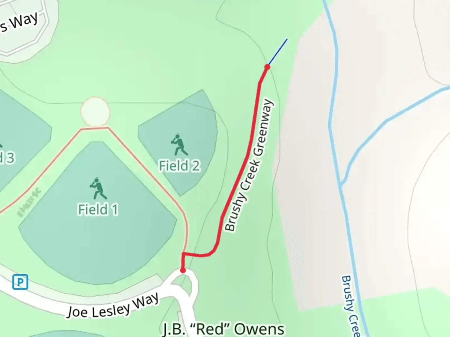 An image depicting the trail Brushy Creek Greenway and its surrounding area.