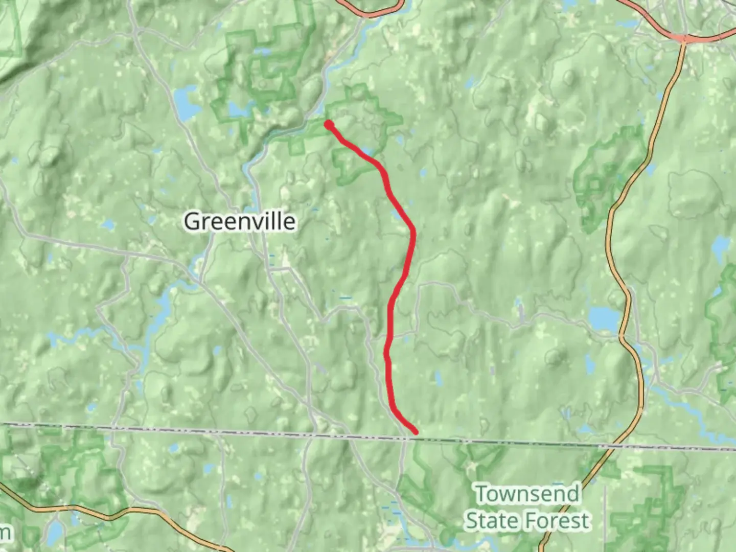 An image depicting the trail Pratt Pond via Mason Railroad Trail and its surrounding area.