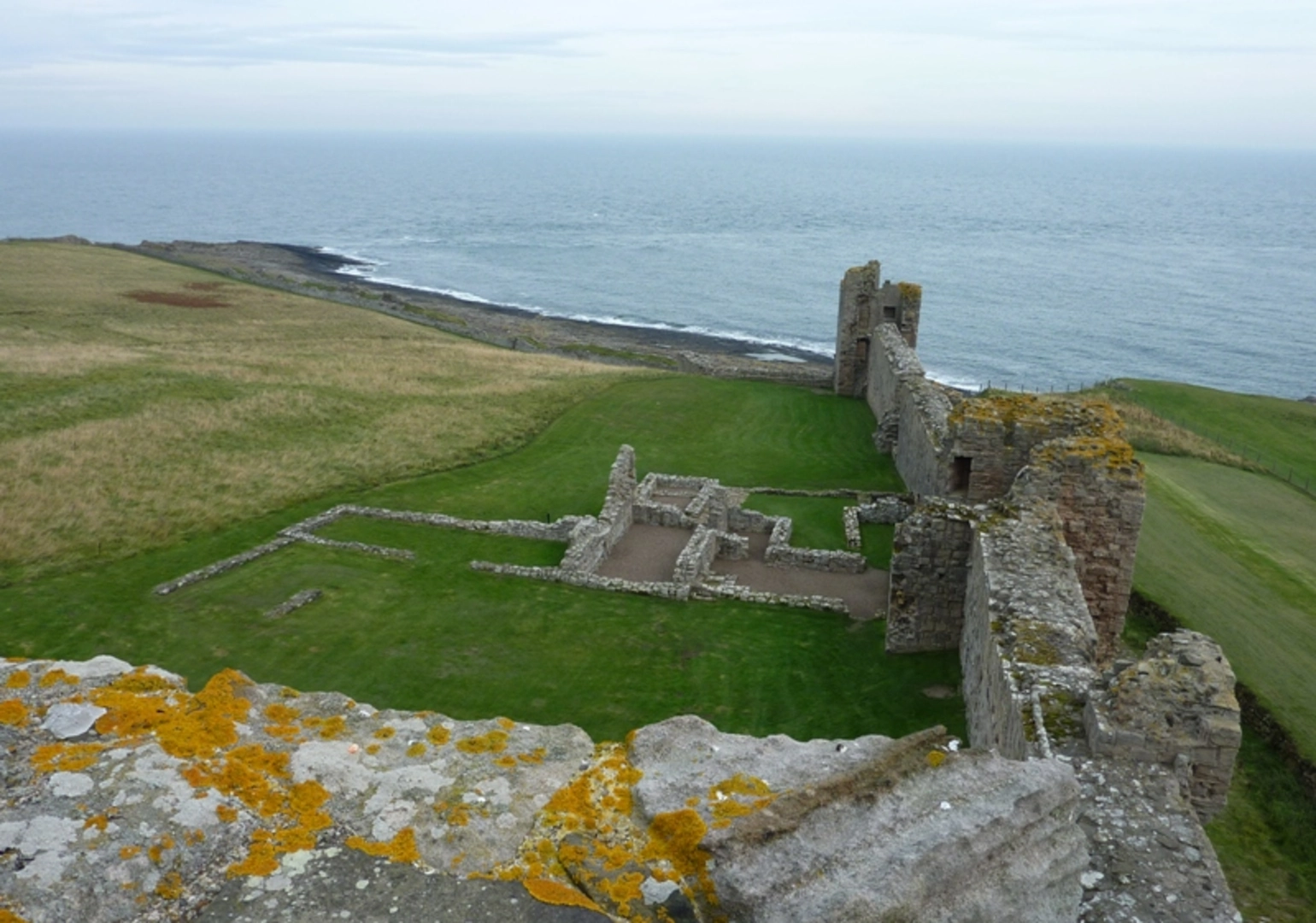An image depicting the trail Dunstanburgh Castle and England Coast Path and its surrounding area.