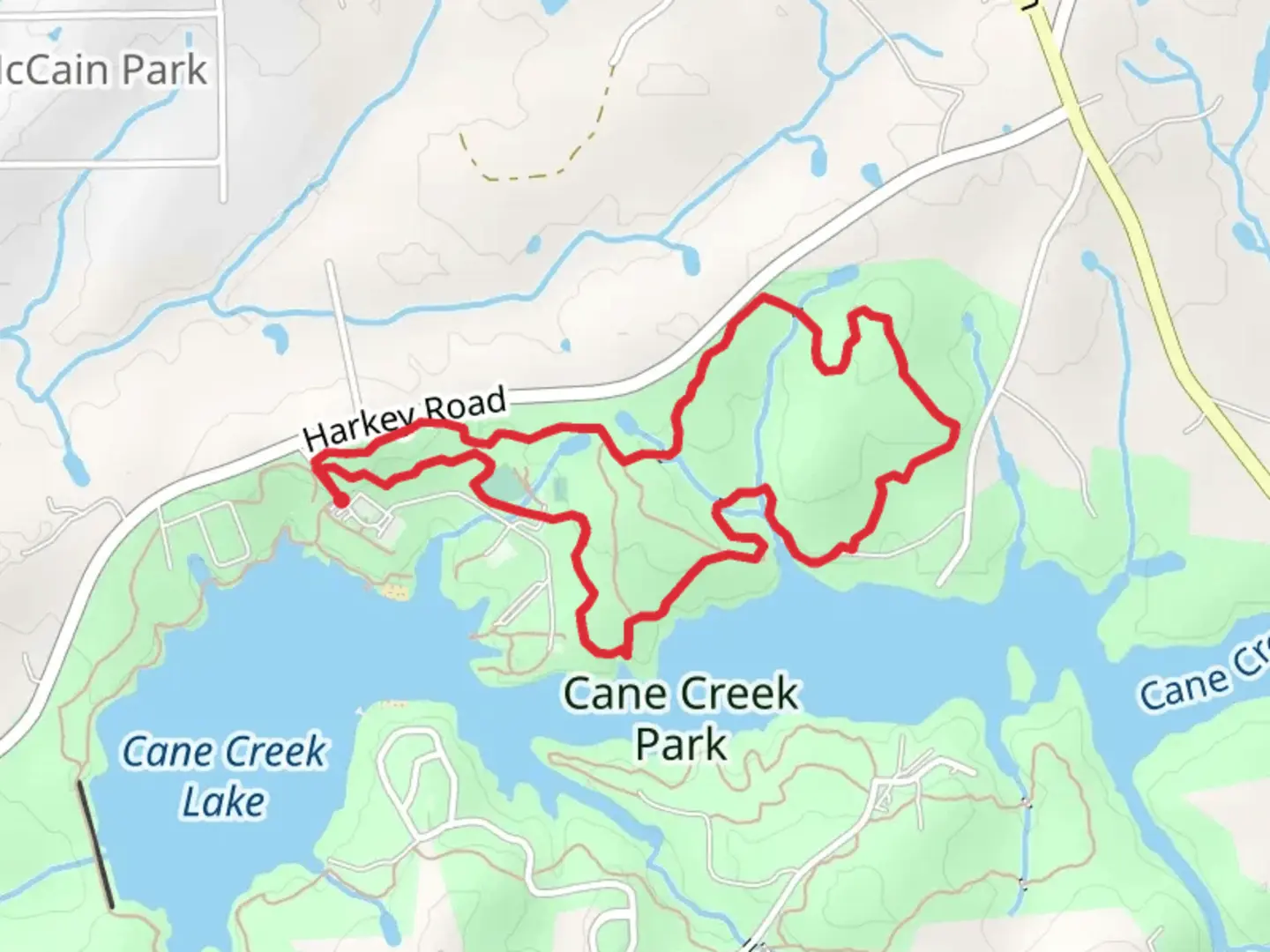 An image depicting the trail Park Red Loop from Cane Creek Lake and its surrounding area.