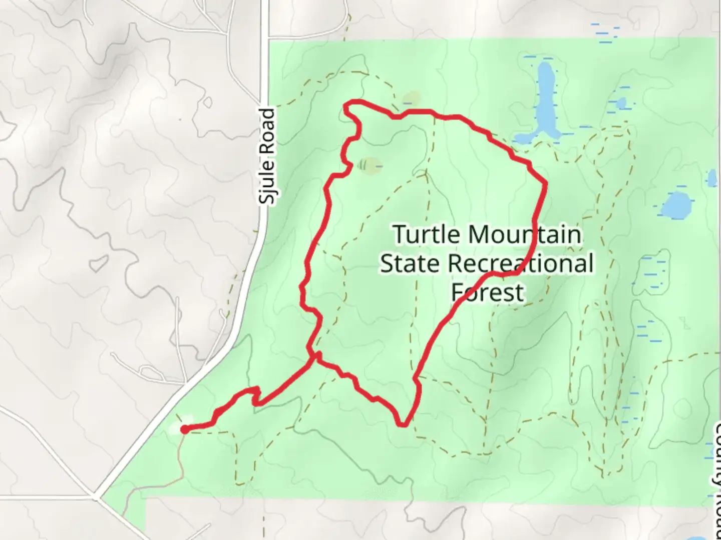 An image depicting the trail Turtle Mountain State Recreation Area Loop and its surrounding area.