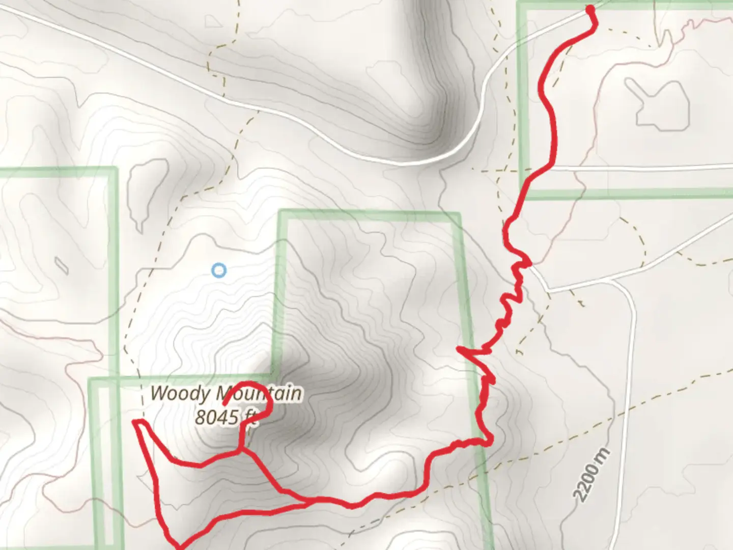 An image depicting the trail Woody Mountain and its surrounding area.