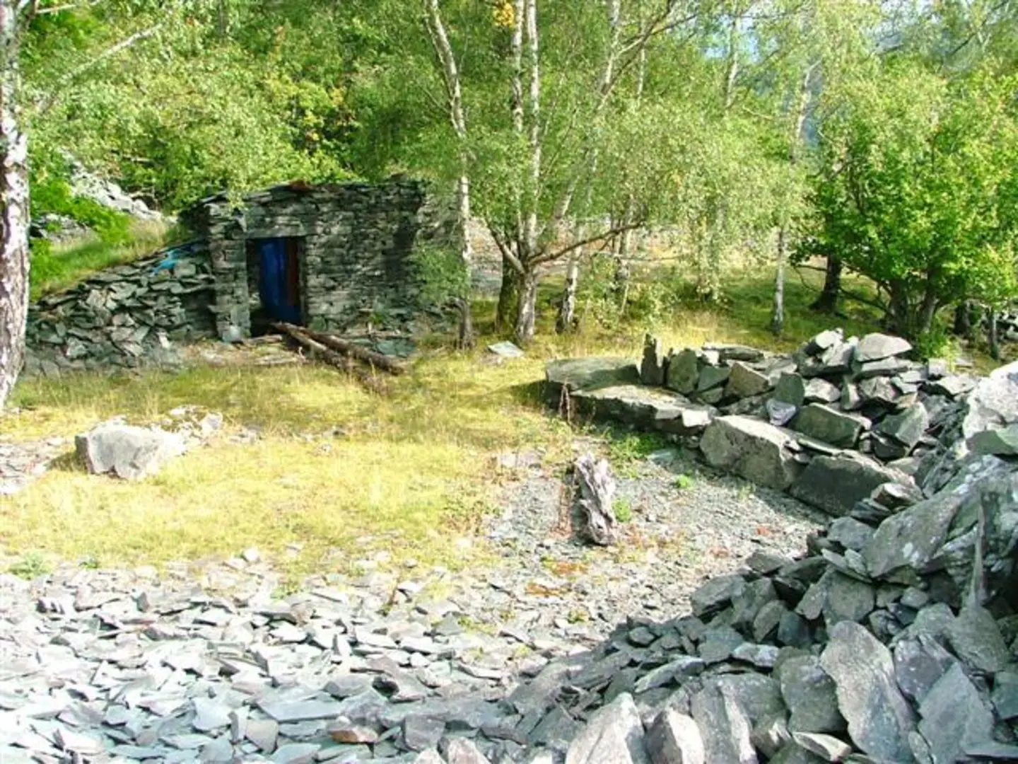 An image depicting the trail Tilberthwaite Gill Waterfall, Wetherlam, Great Carrs and Little Langdale Tarn Loop - Stang End and its surrounding area.