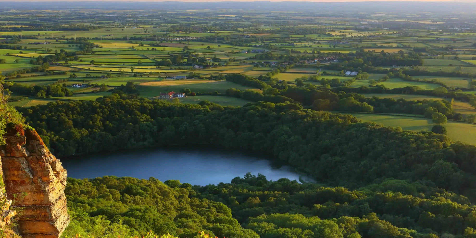 An image depicting the trail Gormire Lake from Sutton Bank National Park Centre and its surrounding area.