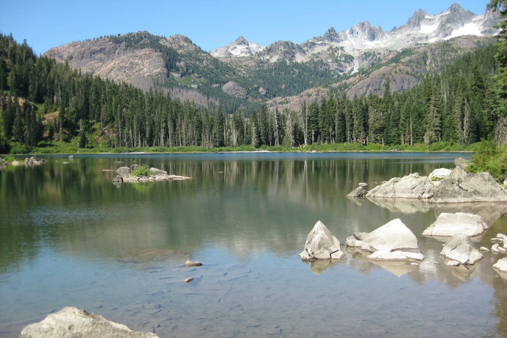An image depicting the trail Squitch Lake via Waptus River Trail and its surrounding area.