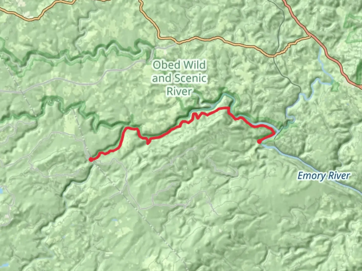 An image depicting the trail Obed Wild and Scenic Trail along Obed River and its surrounding area.