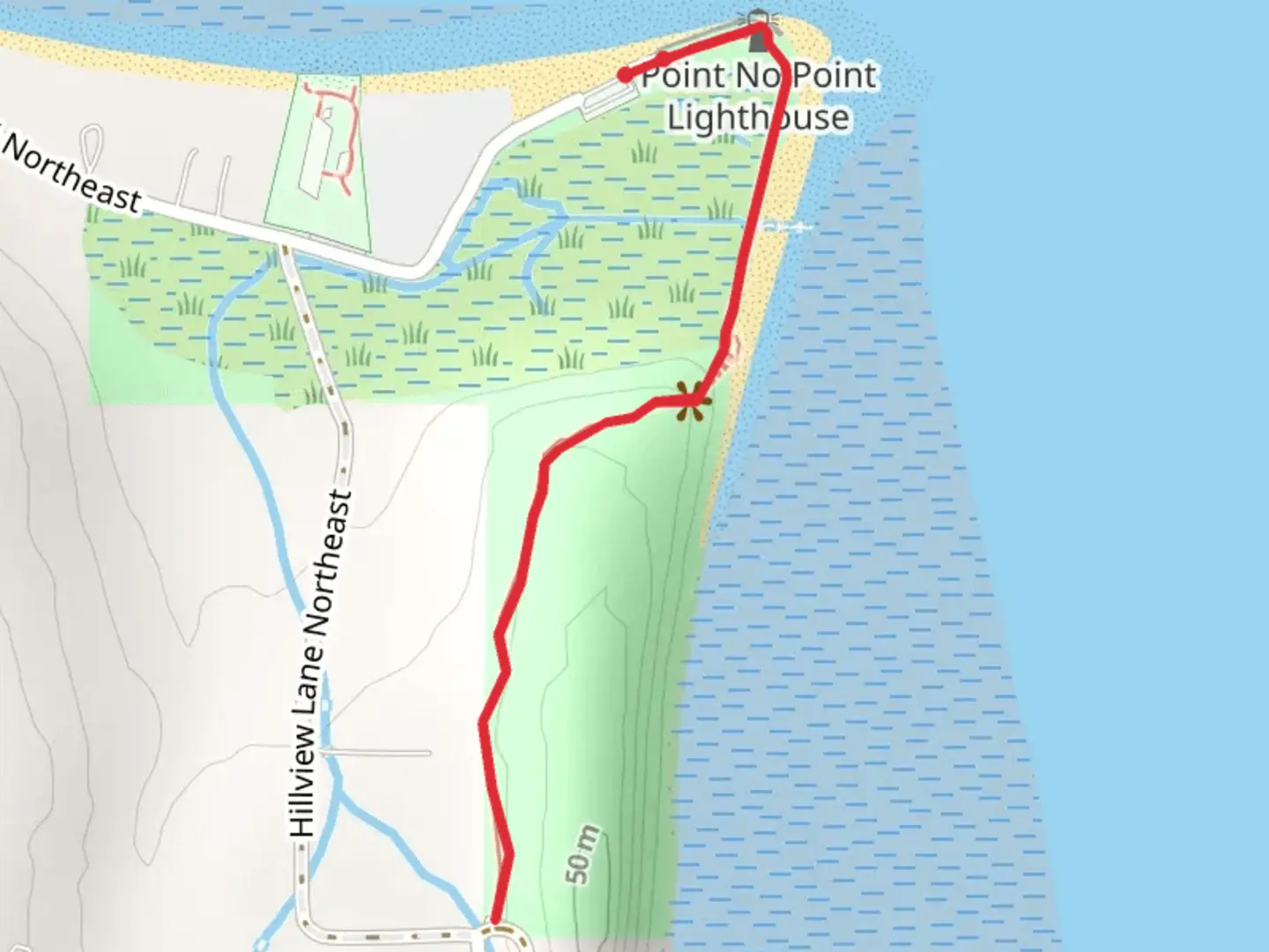 An image depicting the trail Point No Point Lighthouse and Park and its surrounding area.