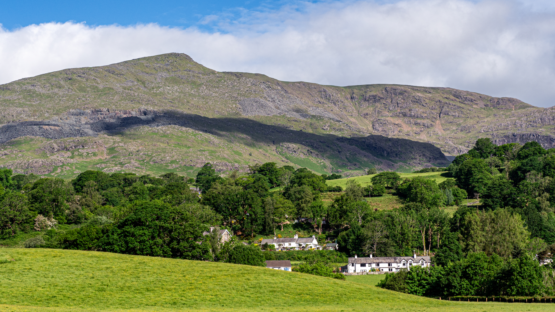 An image depicting the trail Coniston Old Man via Low Water and its surrounding area.