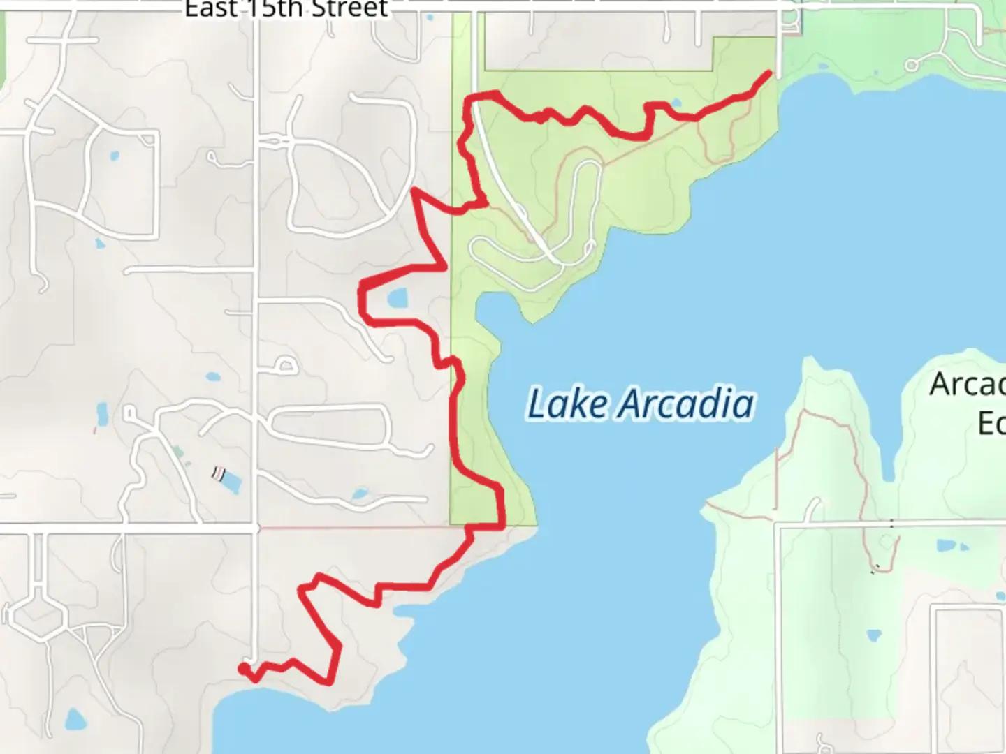 An image depicting the trail Along Lake Arcadia and its surrounding area.