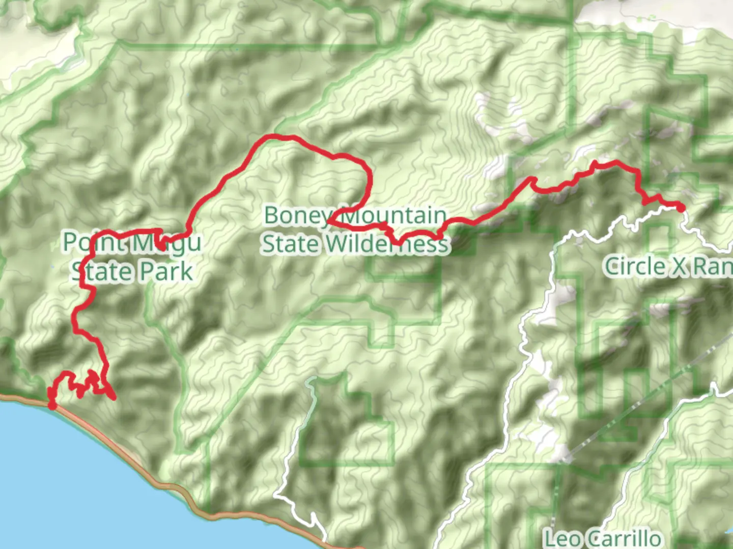 An image depicting the trail Mishe Mokwa Trail - Backbone Trail from Triunfo Pass and its surrounding area.