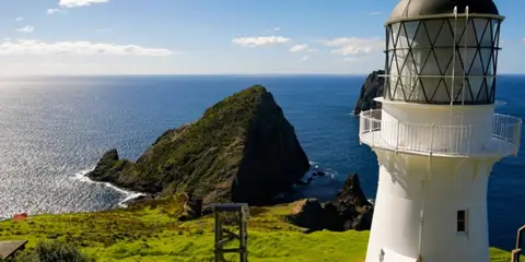 An image depicting the trail Cape Brett Track and its surrounding area.