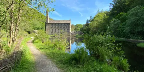 An image depicting the trail Mill Walk at Hardcastle Crags and its surrounding area.