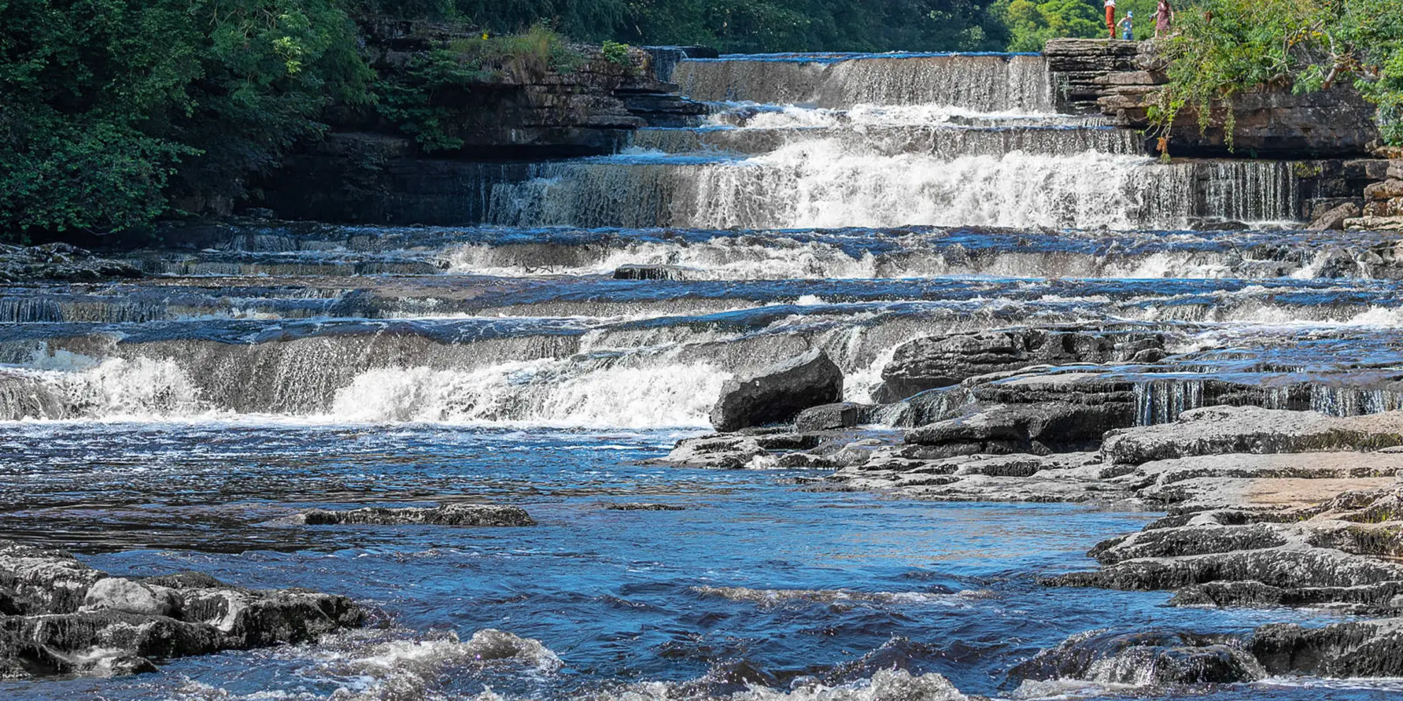 An image depicting the trail Penhill and West Burton from Aysgarth Falls and its surrounding area.