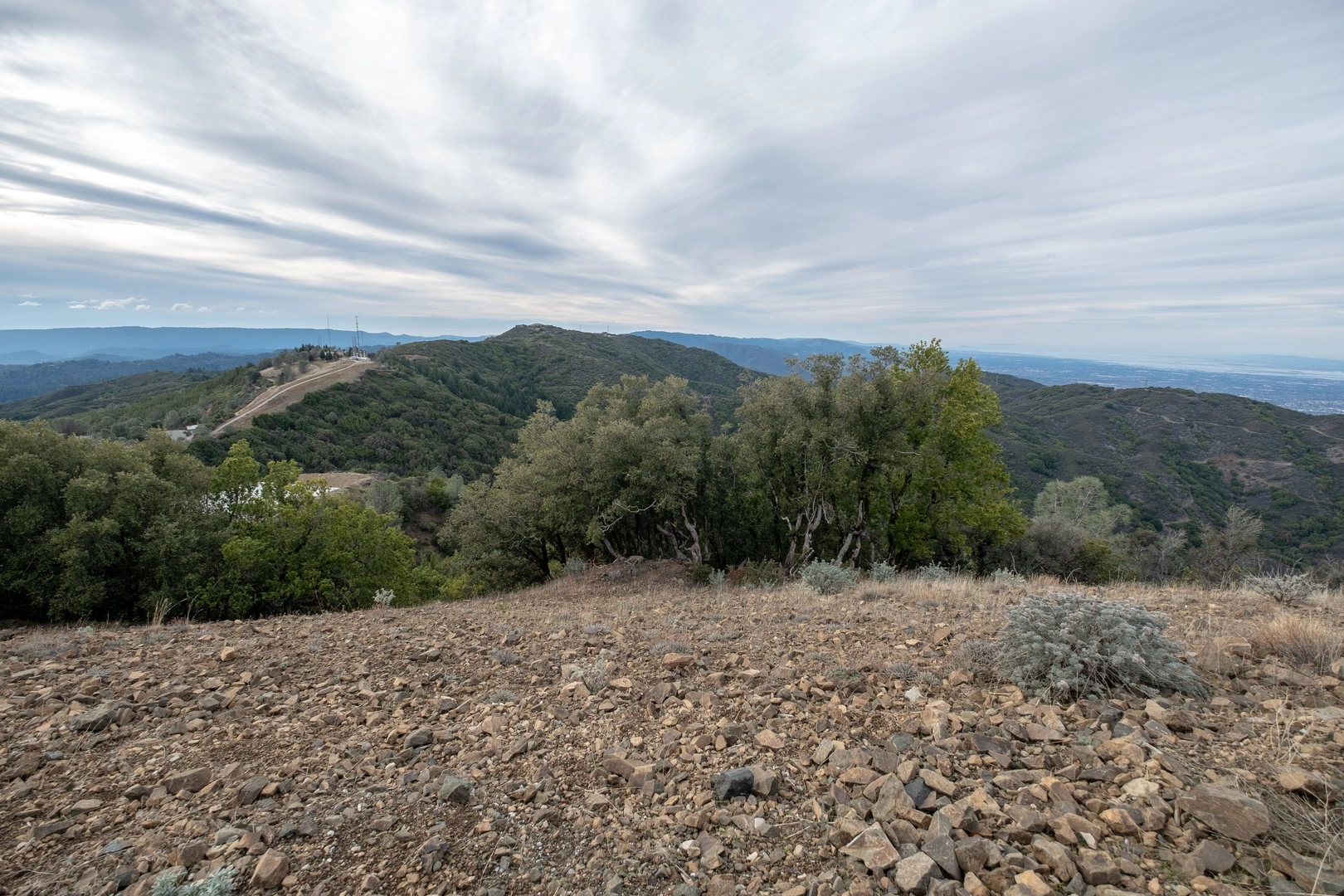 An image depicting the trail Woods Trail, Barlow Road and Mount Umunhum Road Loop and its surrounding area.