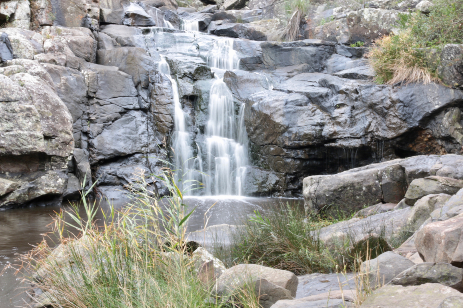 An image depicting the trail Deep Creek Waterfall Track from Tent Rock Road and its surrounding area.