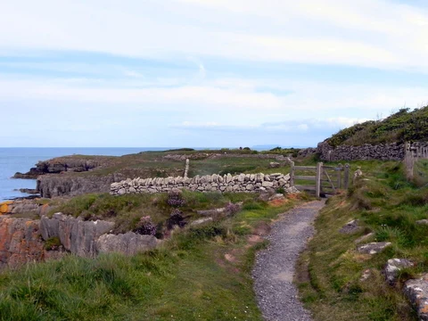 An image depicting the trail Benllech to Moelfre Coastal Path Walk and its surrounding area.