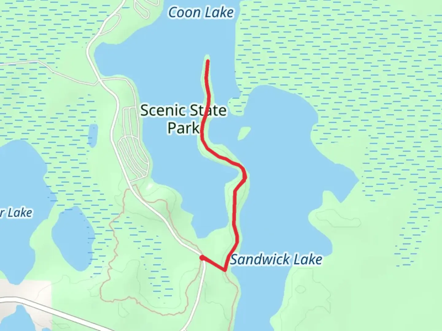 An image depicting the trail Scenic State Park - Coon Lake and its surrounding area.