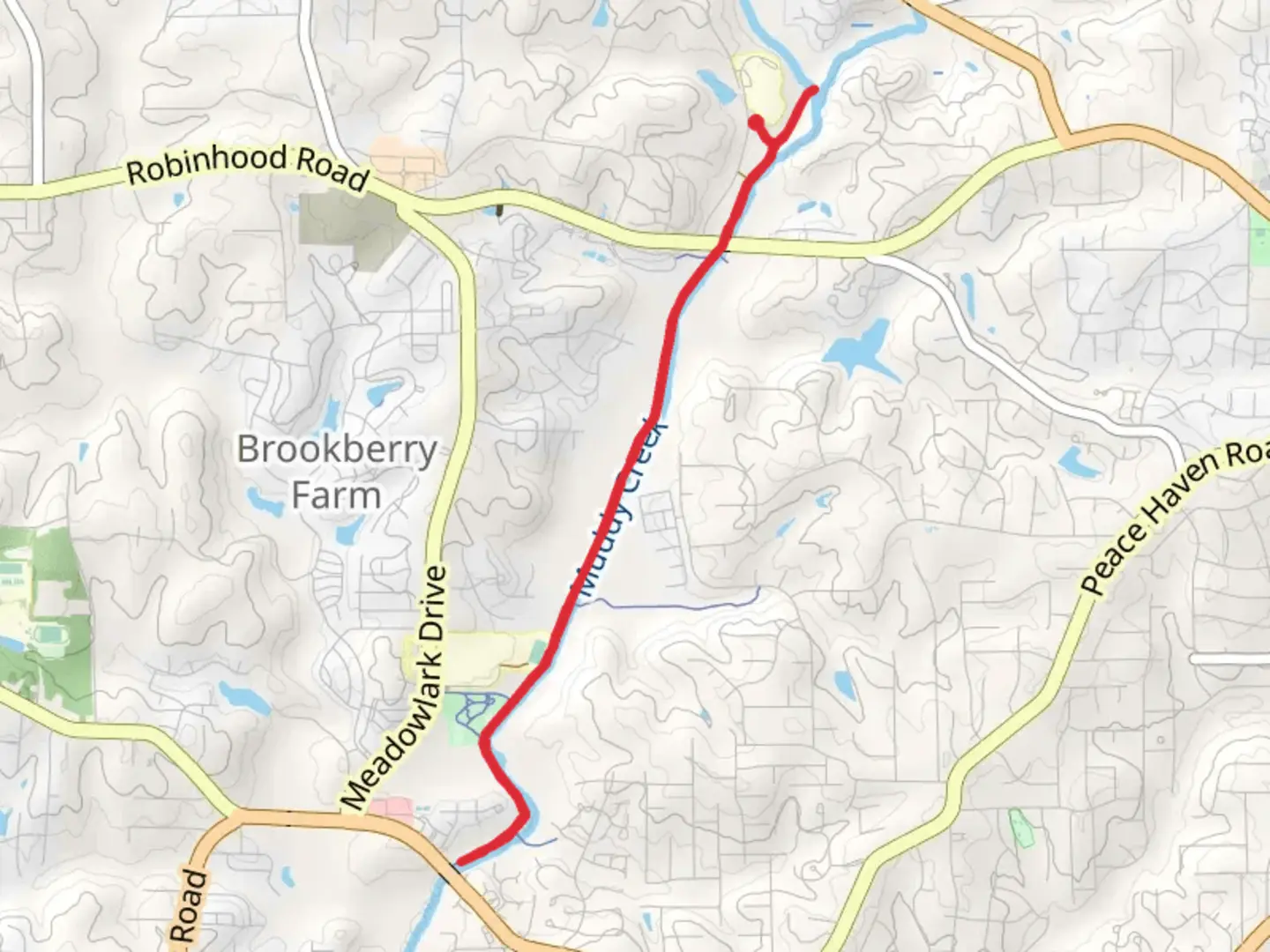 An image depicting the trail Muddy Creek Greenway and its surrounding area.