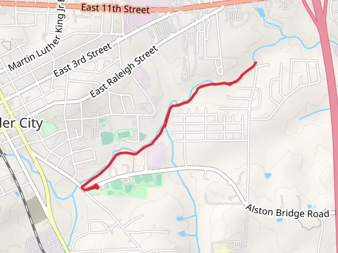 An image depicting the trail Loves Creek Greenway and its surrounding area.