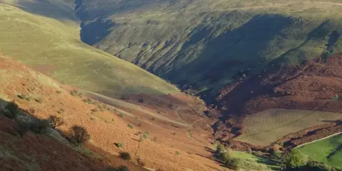 An image depicting the trail Waun Fach and Y Grib from Pengenfford Castell Dinas and its surrounding area.