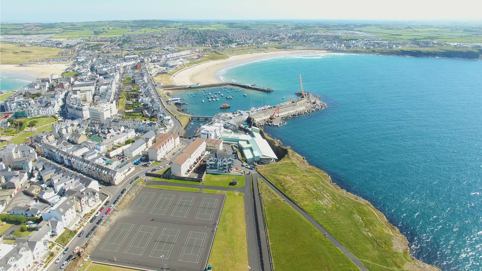 An image depicting the trail West Bay and Ramore Head and its surrounding area.