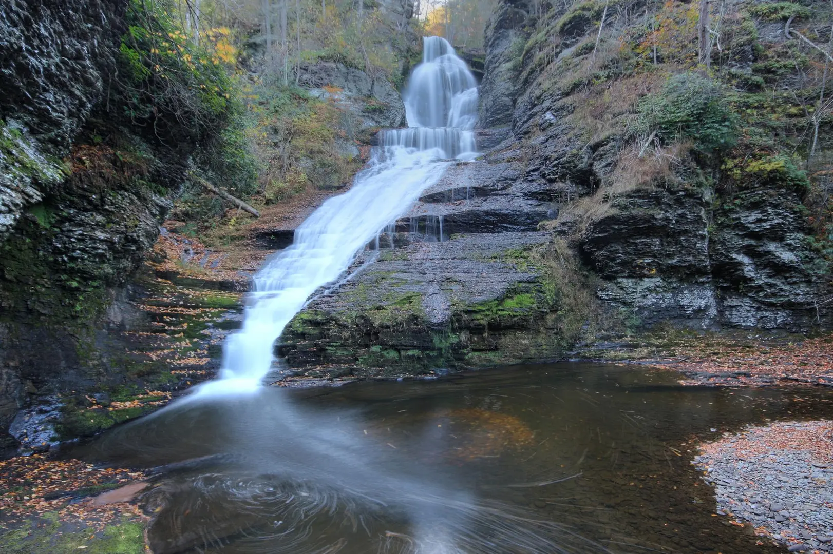 An image depicting the trail Dingmans Falls and Dingmans Creek and its surrounding area.