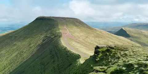 An image depicting the trail Pen y Fan from Cwmgwdi near Brecon and its surrounding area.