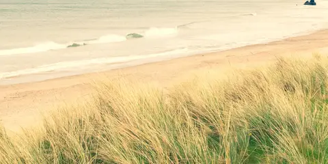 An image depicting the trail Fairhead Loch Na Crannóige Walk and its surrounding area.