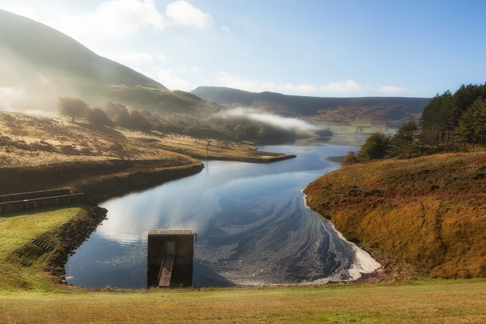An image depicting the trail East of Manchester Loop from Dovestones Reservoir and its surrounding area.