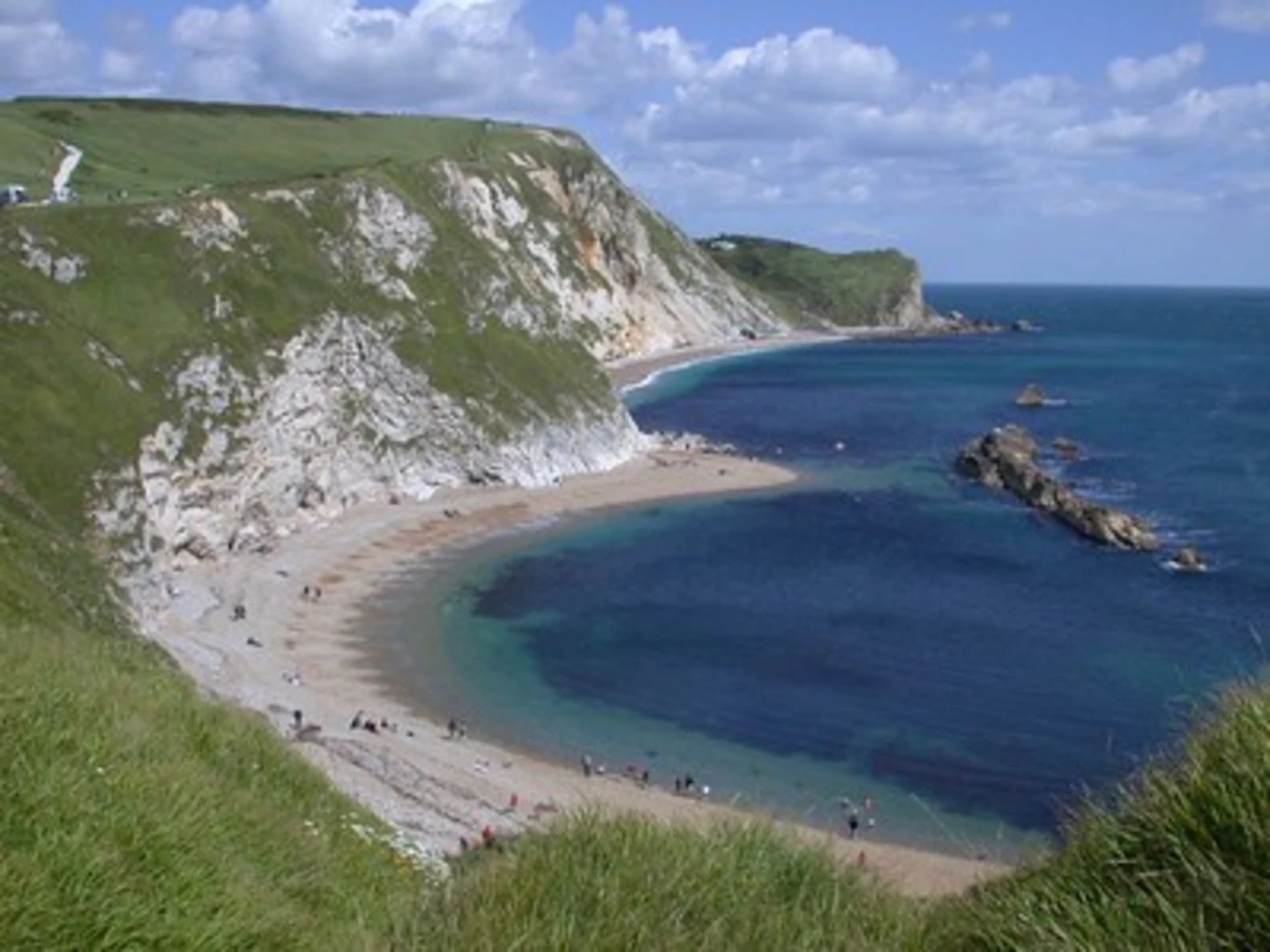 An image depicting the trail Lulworth Cove via H Way and its surrounding area.