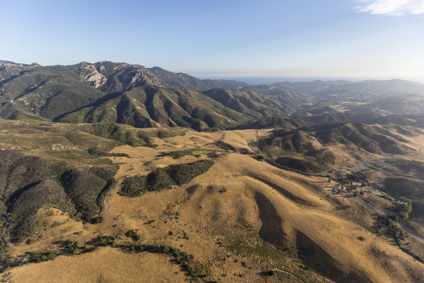 An image depicting the trail Tri - Peaks via Backbone Trail and its surrounding area.
