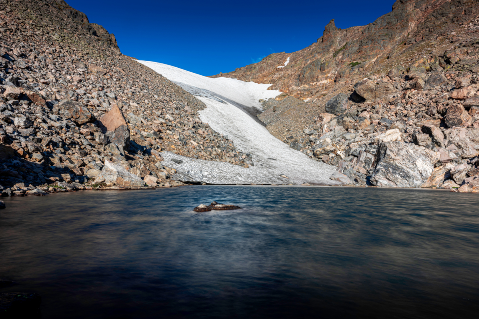 An image depicting the trail Andrews Glacier via Sky Pond Trail and its surrounding area.