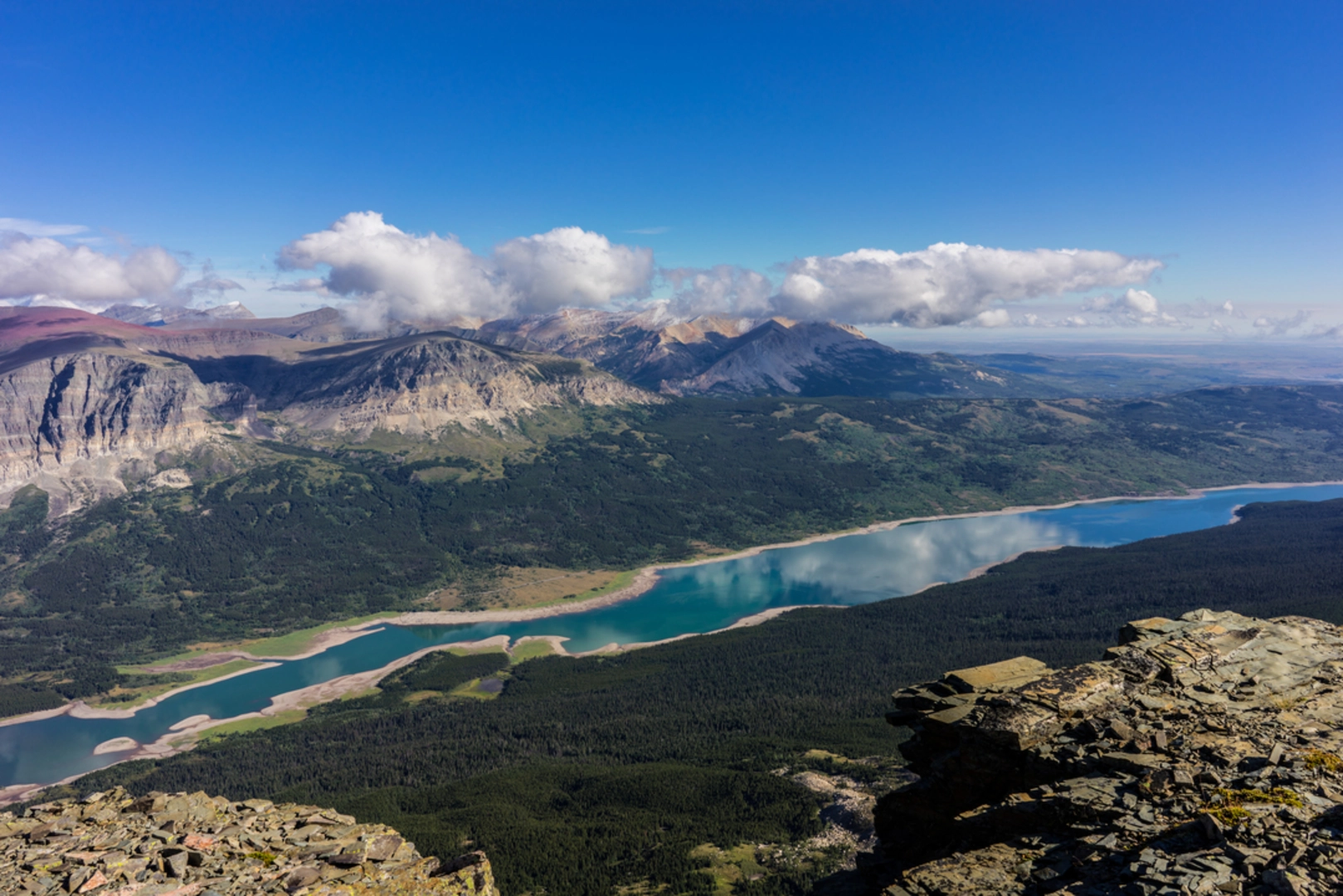 An image depicting the trail Many Glacier to Chief Mountain Trail via CDT and its surrounding area.