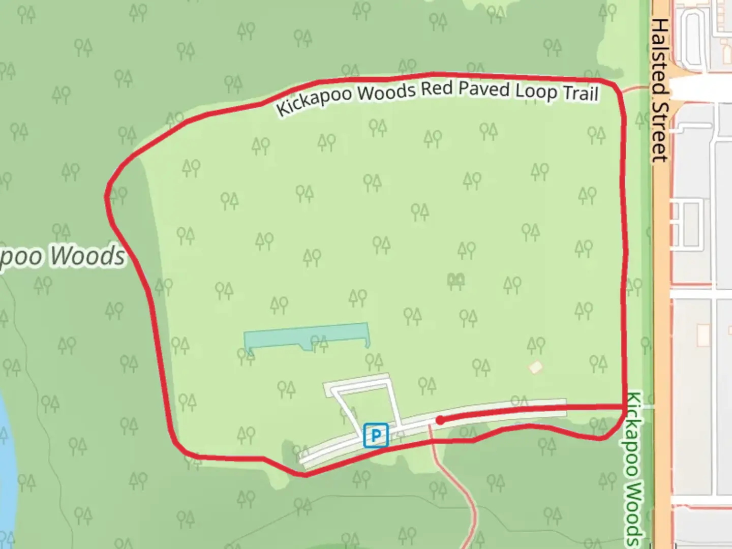 An image depicting the trail Kickapoo Woods Red Paved Loop Trail and its surrounding area.