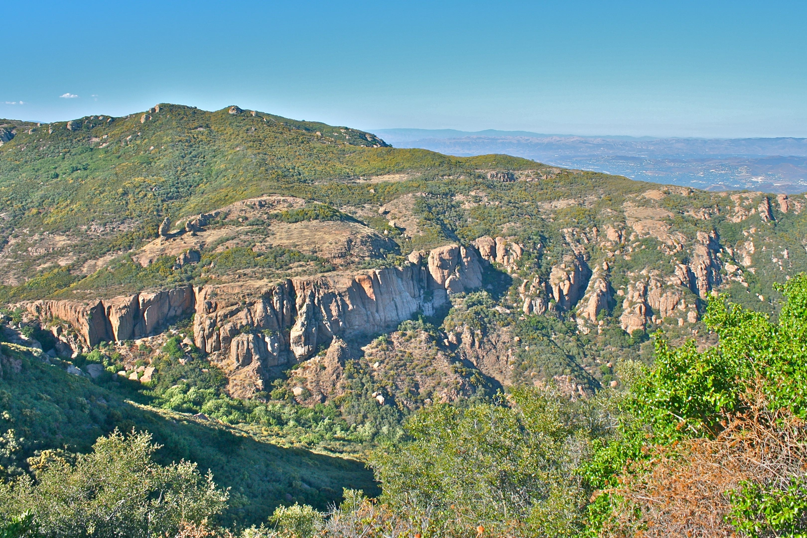 An image depicting the trail Backbone Trail - Malibu Canyon Road and its surrounding area.