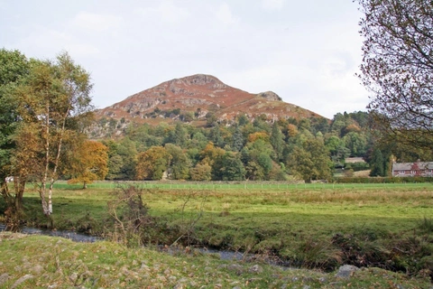 An image depicting the trail River Rothay and Helm Crag and its surrounding area.