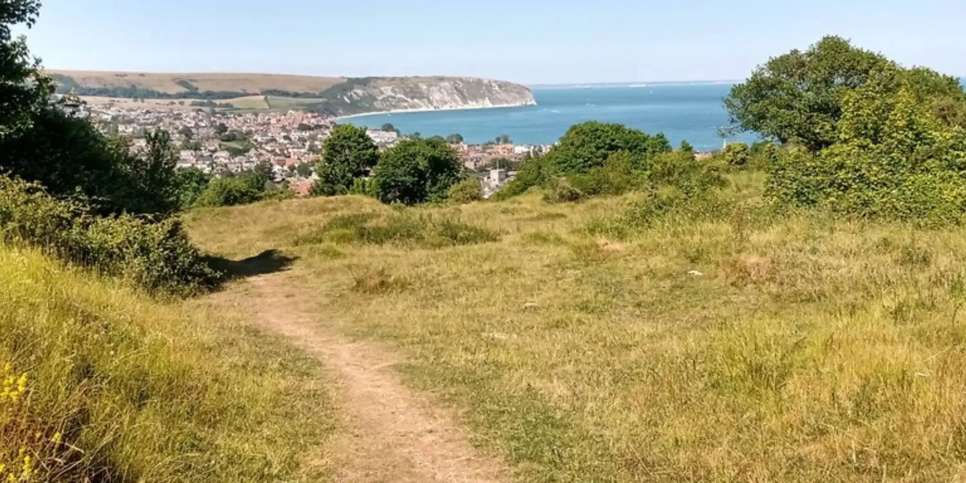 An image depicting the trail Swanage Coastal Park - Priests Way Walk and its surrounding area.