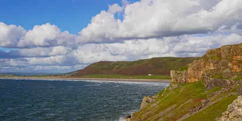 An image depicting the trail Gower Coast Path and its surrounding area.